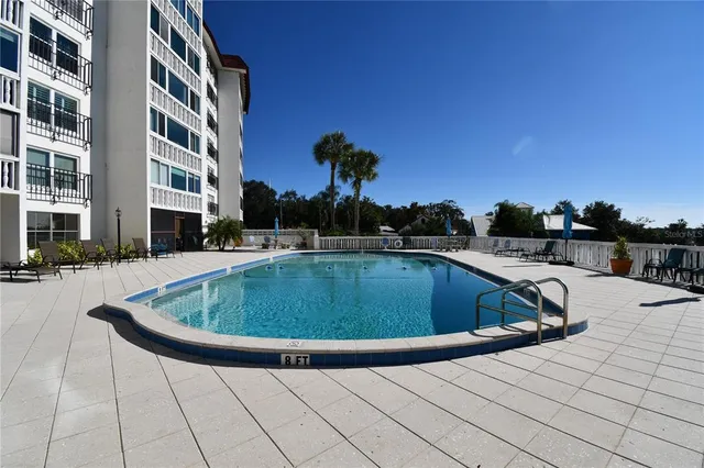a view of a swimming pool with a yard