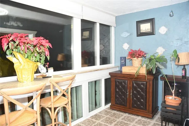 a dining room with chandelier fan and wooden floor