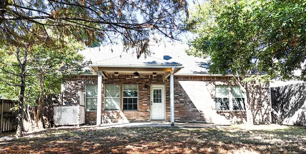 a view of a house with a tree in front
