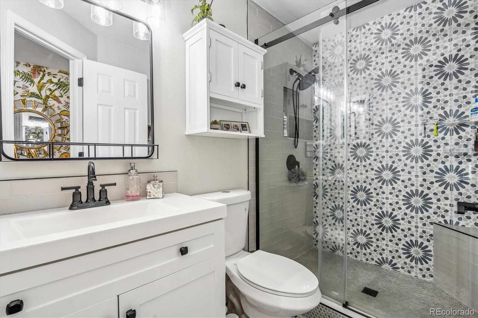 5250 South Huron Way, Unit 7104 Littleton, CO 80120 - Photo 12 of 19 a bathroom with a sink toilet vanity and shower