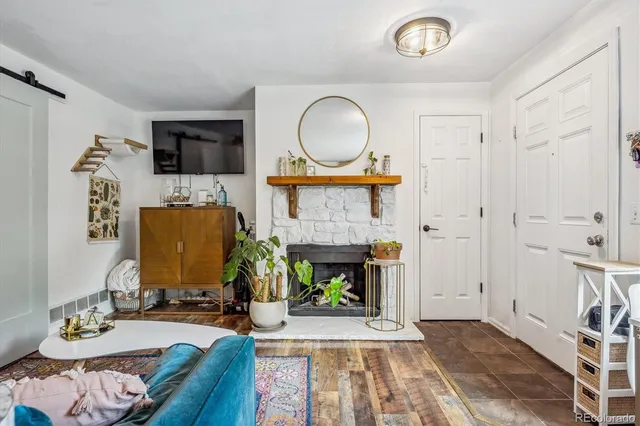 a living room with furniture a fireplace and a flat screen tv