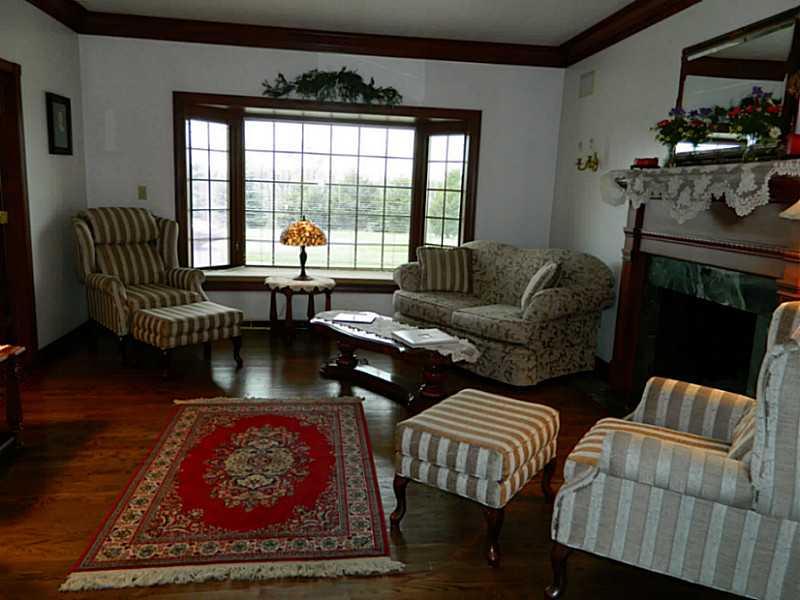 318 Quarry Road Washington, PA 15301 - Photo 6 of 25 Exterior Front. The large formal living room is located just off the foyer through glass paned french doors. The room is accented by hardwood flooring, a large bay window with window seat and a gas fireplace with beautiful marble surround.