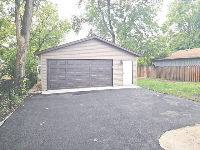 a view of backyard of house with garage