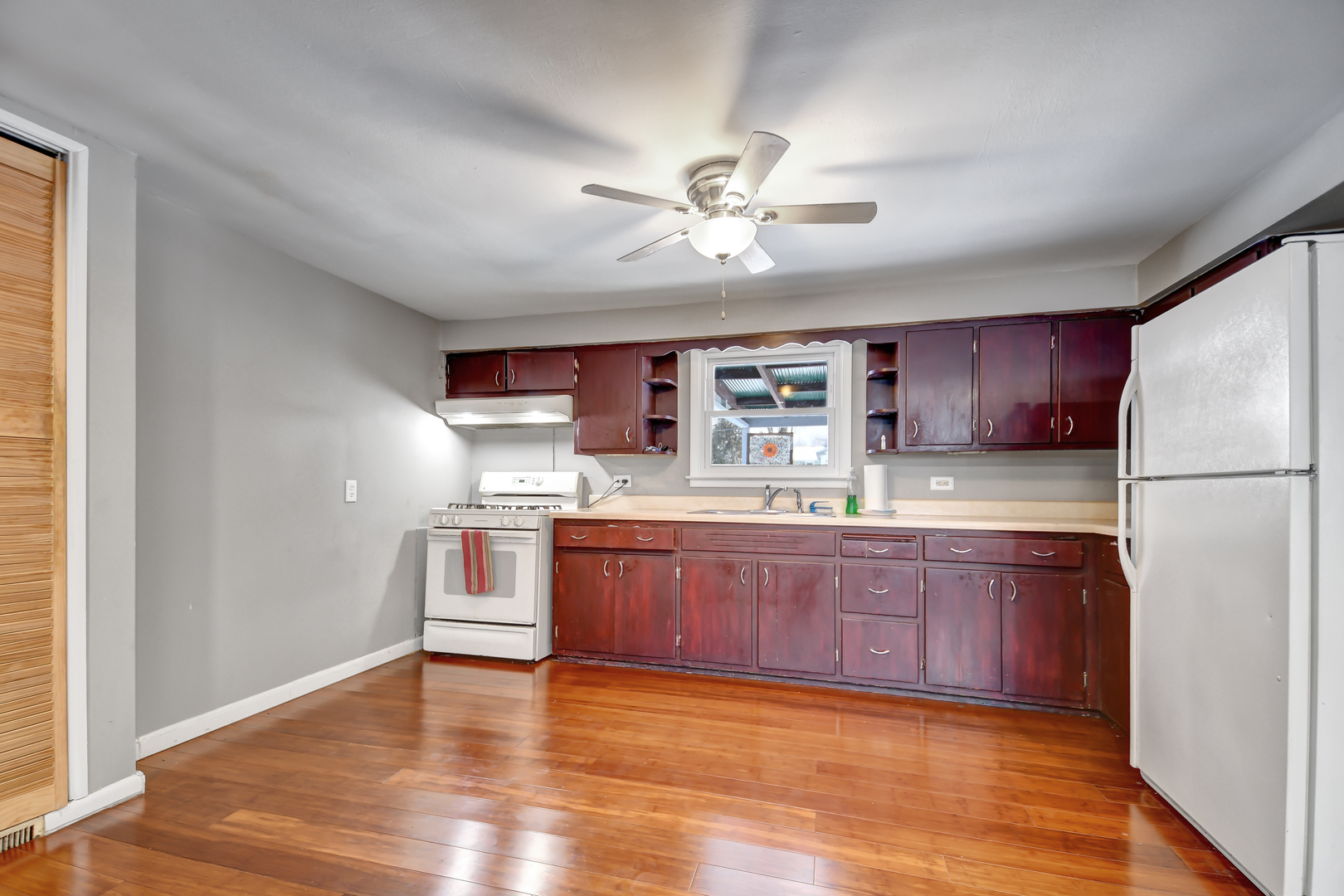 15047 Copter Lane Romeoville, IL 60446 - Photo 9 of 18 a large kitchen with stainless steel appliances granite countertop a refrigerator a sink dishwasher a stove with wooden floors