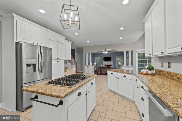 a kitchen with white cabinets and refrigerator