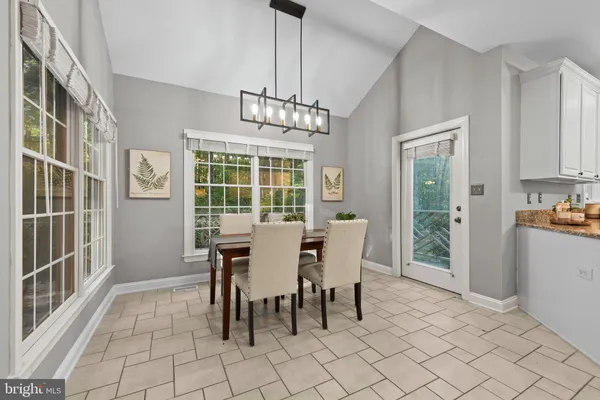 a living room with furniture fireplace and a large window