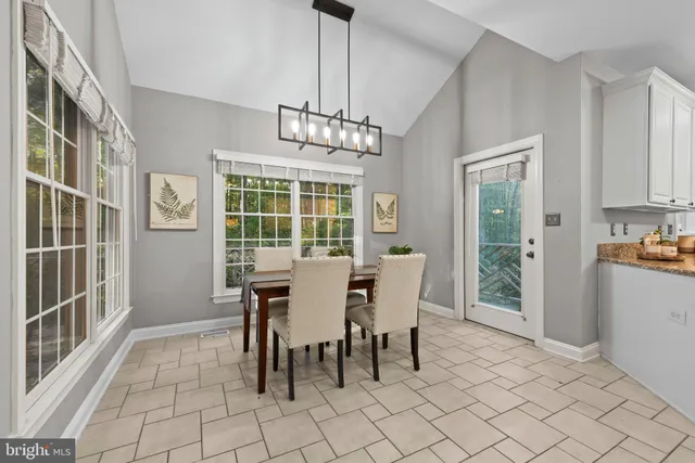 a living room with furniture fireplace and a large window