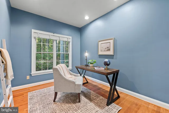 a living room with a couch and paintings on the wall