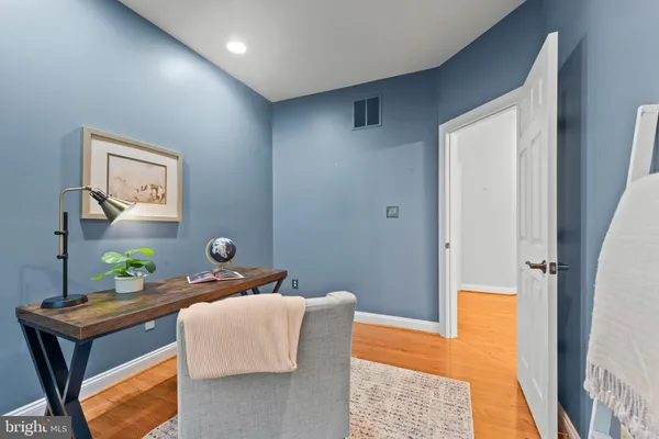 a view of hallway with wooden floor