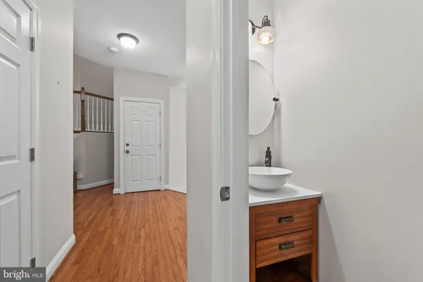 a view of a hallway with wooden floor and entryway