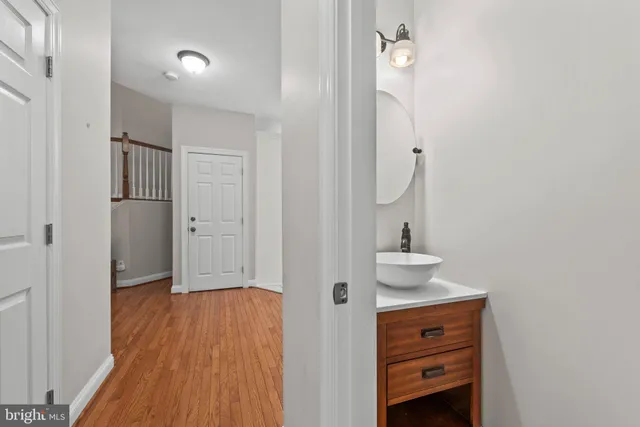 a view of a hallway with wooden floor and entryway