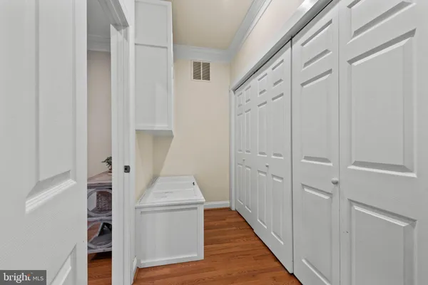 a spacious bedroom with a bed a table and a large window
