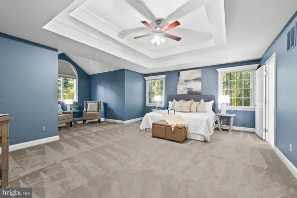 a bed room with a bed and a chair