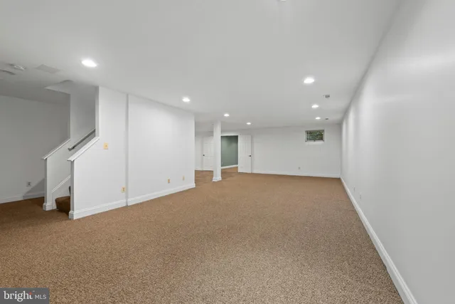 a view of an empty room with a fireplace