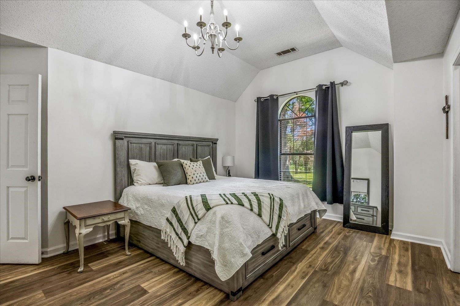 184 Cherokee Road Millington, TN 38053 - Photo 8 of 27 Vaulted ceiling bedroom featuring wood-finish flooring and an arched window