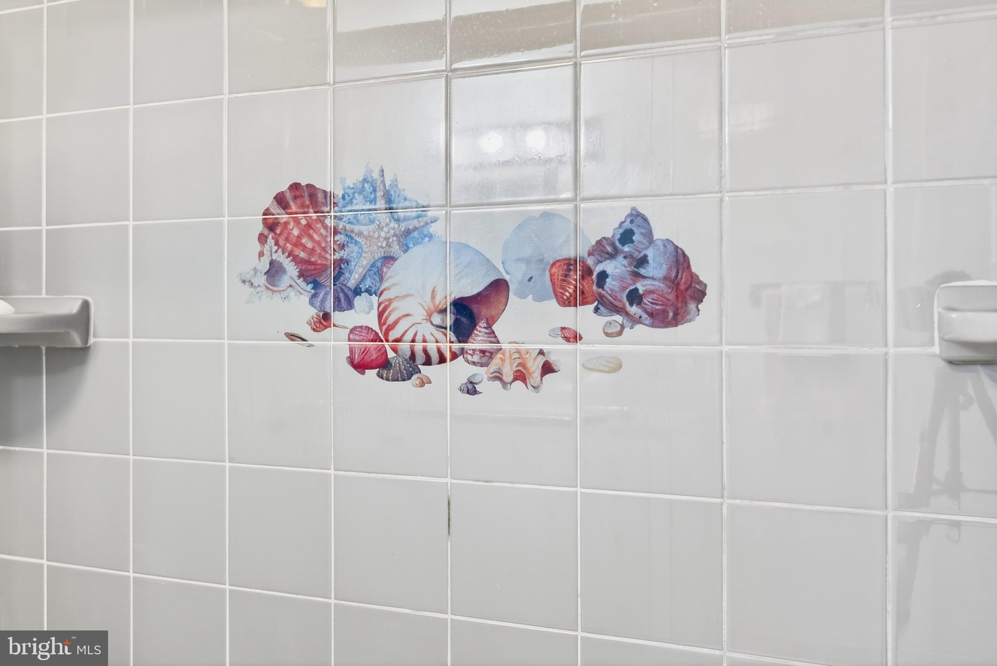 4 Rona Lane Manahawkin, NJ 08050 - Photo 23 of 28 Whimsical seashell mural in tiled space.