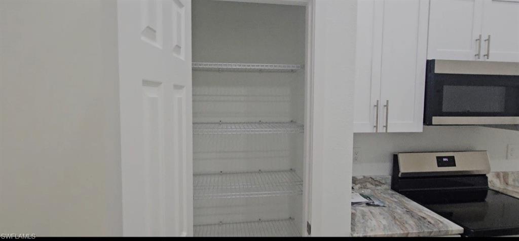 4518 26th Street Southwest Lehigh Acres, FL 33973 - Photo 6 of 15 a view of kitchen and microwave