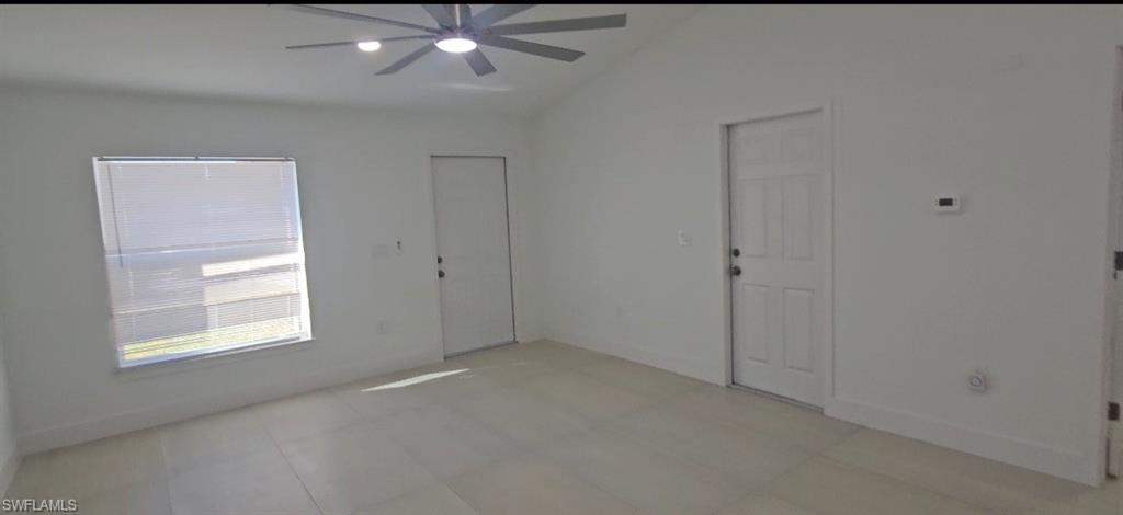 4518 26th Street Southwest Lehigh Acres, FL 33973 - Photo 7 of 15 an empty room with chandelier fan and windows