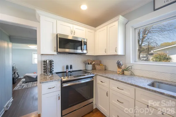 a kitchen with stainless steel appliances a stove a microwave and a refrigerator
