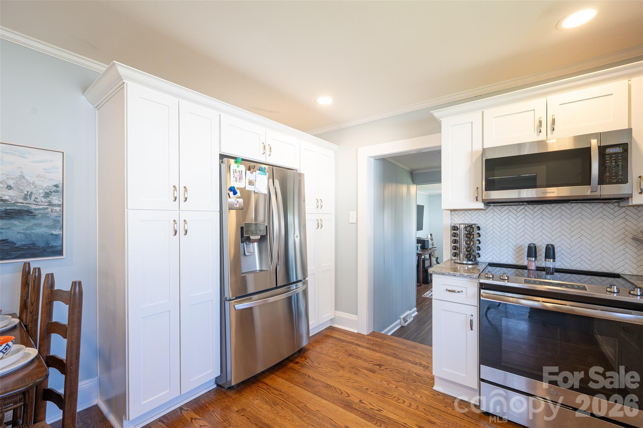 206 Bates Avenue Cherryville, NC 28021 - Photo 13 of 38 a kitchen with stainless steel appliances a stove a microwave and a refrigerator