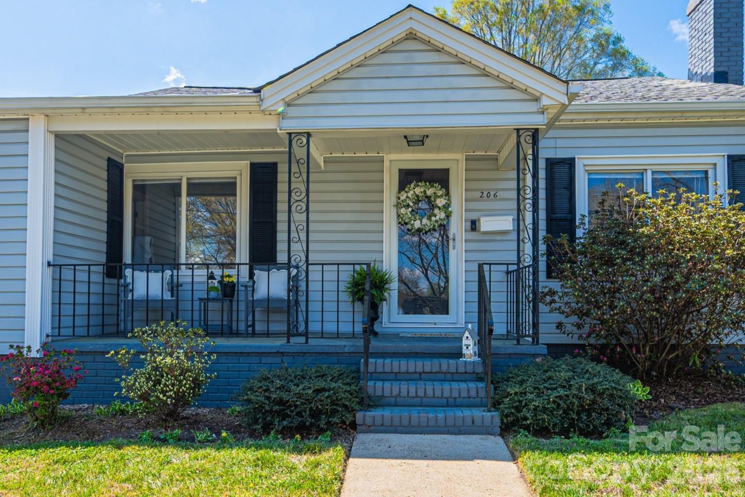 206 Bates Avenue Cherryville, NC 28021 - Photo 2 of 38 a front view of a house with a garden