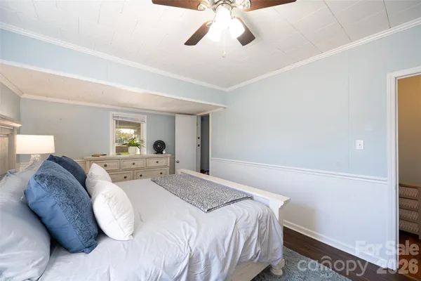 a spacious bedroom with a bed and a chandelier