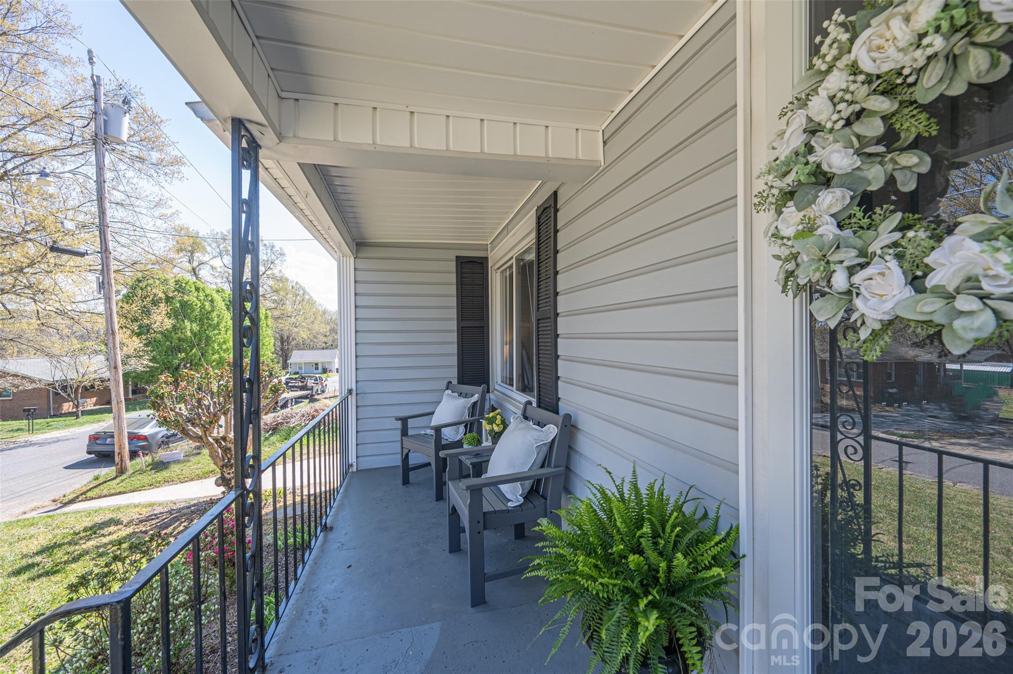 206 Bates Avenue Cherryville, NC 28021 - Photo 3 of 38 a porch with chairs and potted plants