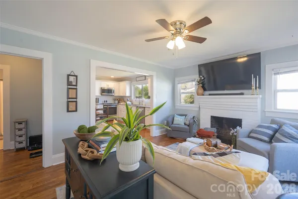 a living room with furniture a fireplace and a flat screen tv