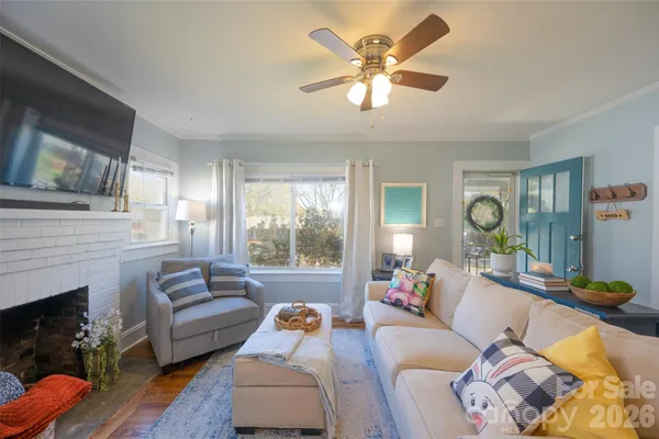 a living room with furniture a fireplace and a flat screen tv