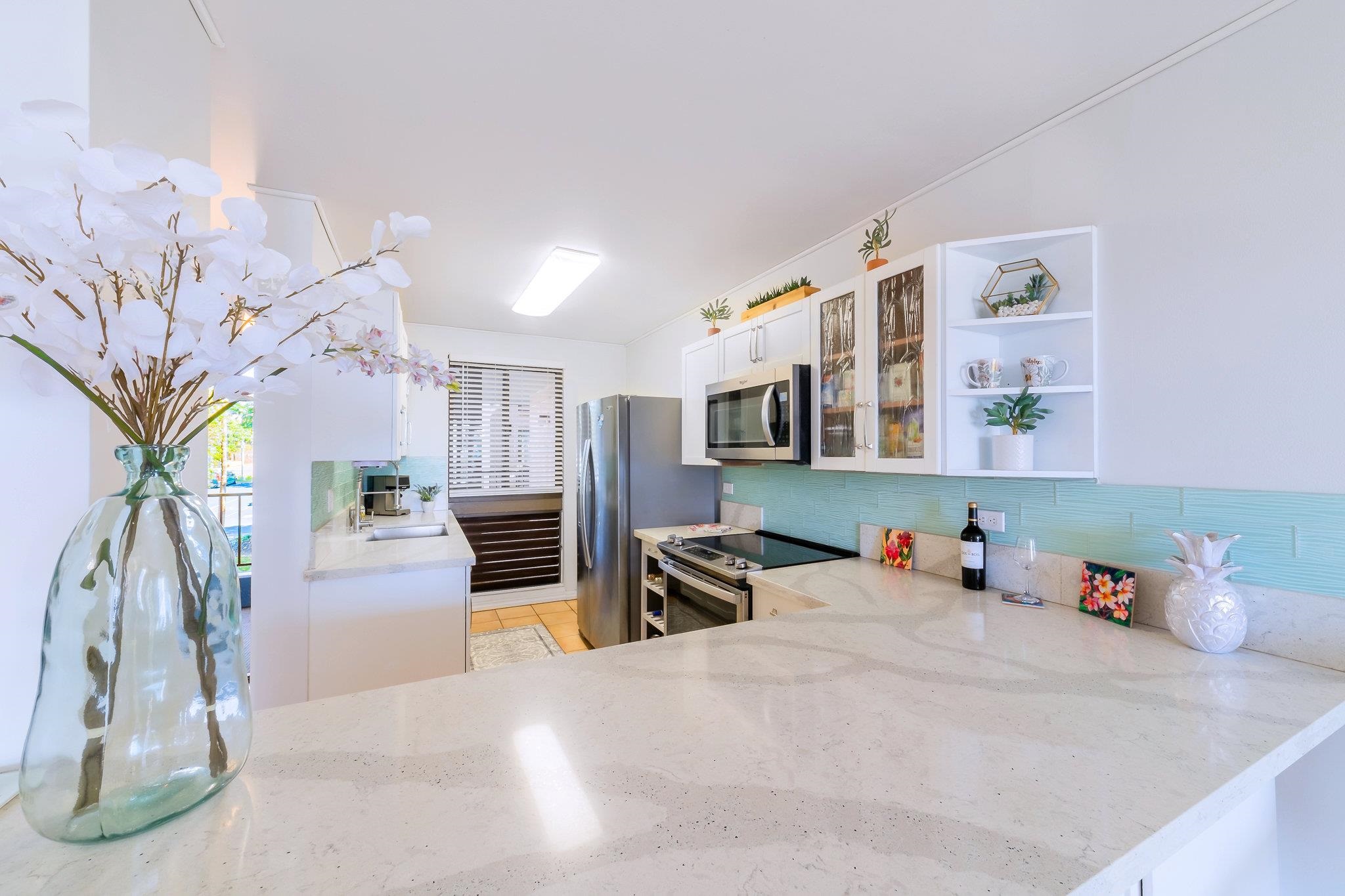 4310 Lower Honoapiilani Road, Unit 302 Lahaina, HI 96761 - Photo 17 of 50 a bedroom with furniture and a potted plant