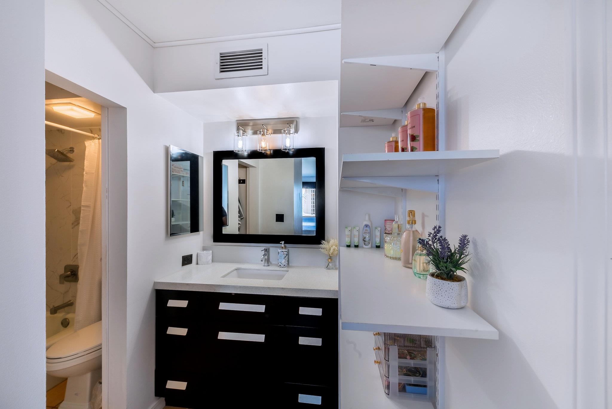 4310 Lower Honoapiilani Road, Unit 302 Lahaina, HI 96761 - Photo 26 of 50 a bathroom with a sink vanity and mirror
