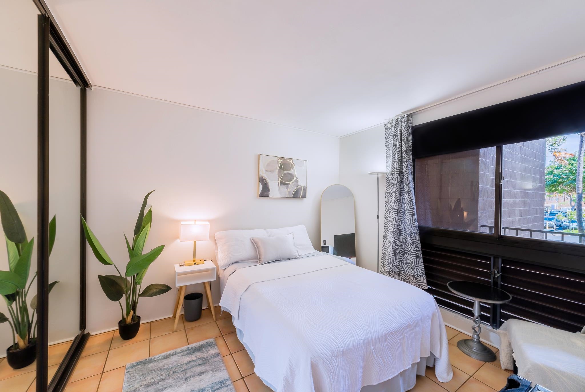 4310 Lower Honoapiilani Road, Unit 302 Lahaina, HI 96761 - Photo 29 of 50 a bedroom with a bed and a flat tv screen on dresser