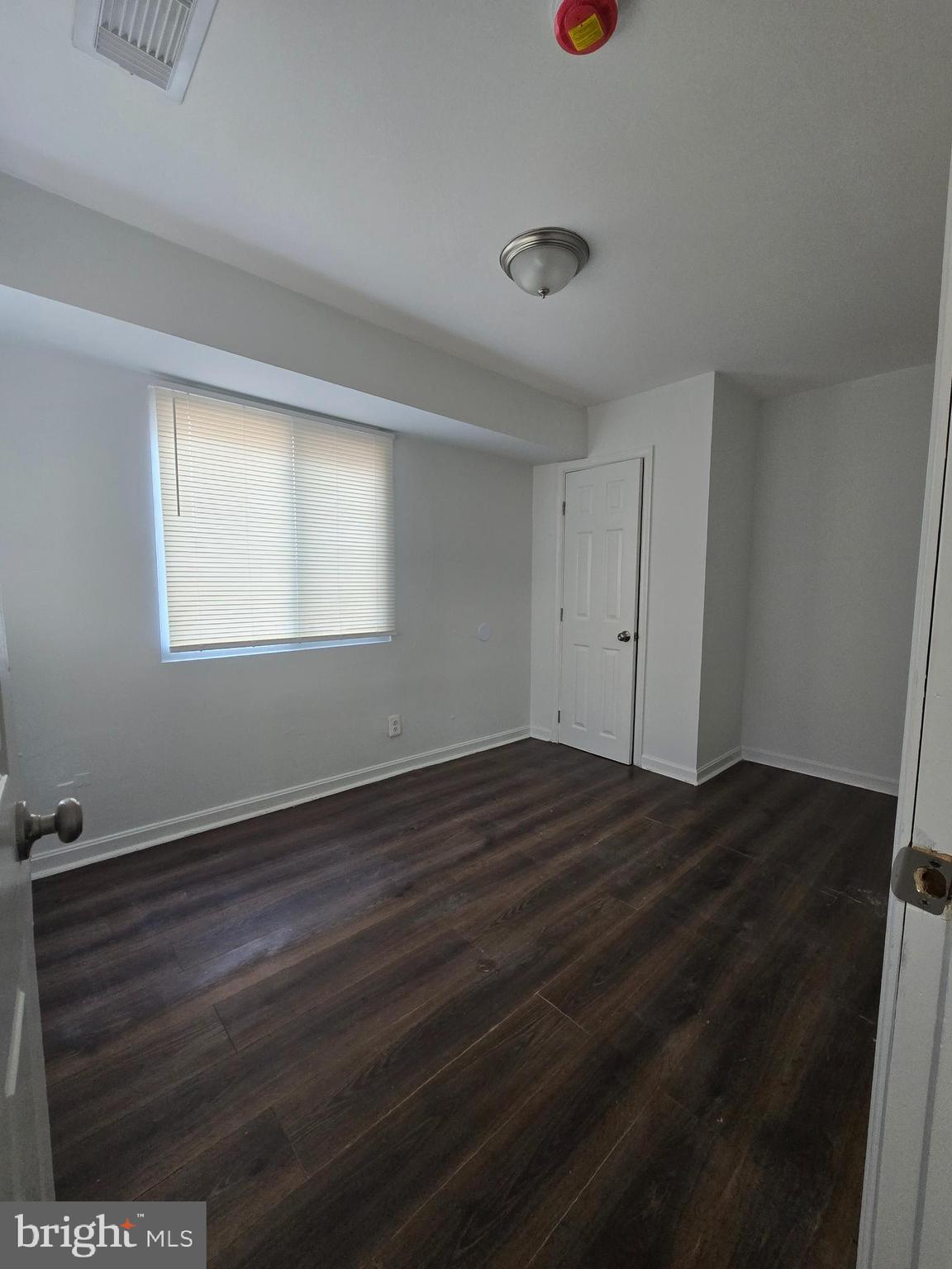 520 56th Street Northeast Washington, DC 20019 - Photo 14 of 15 an empty room with wooden floor and windows