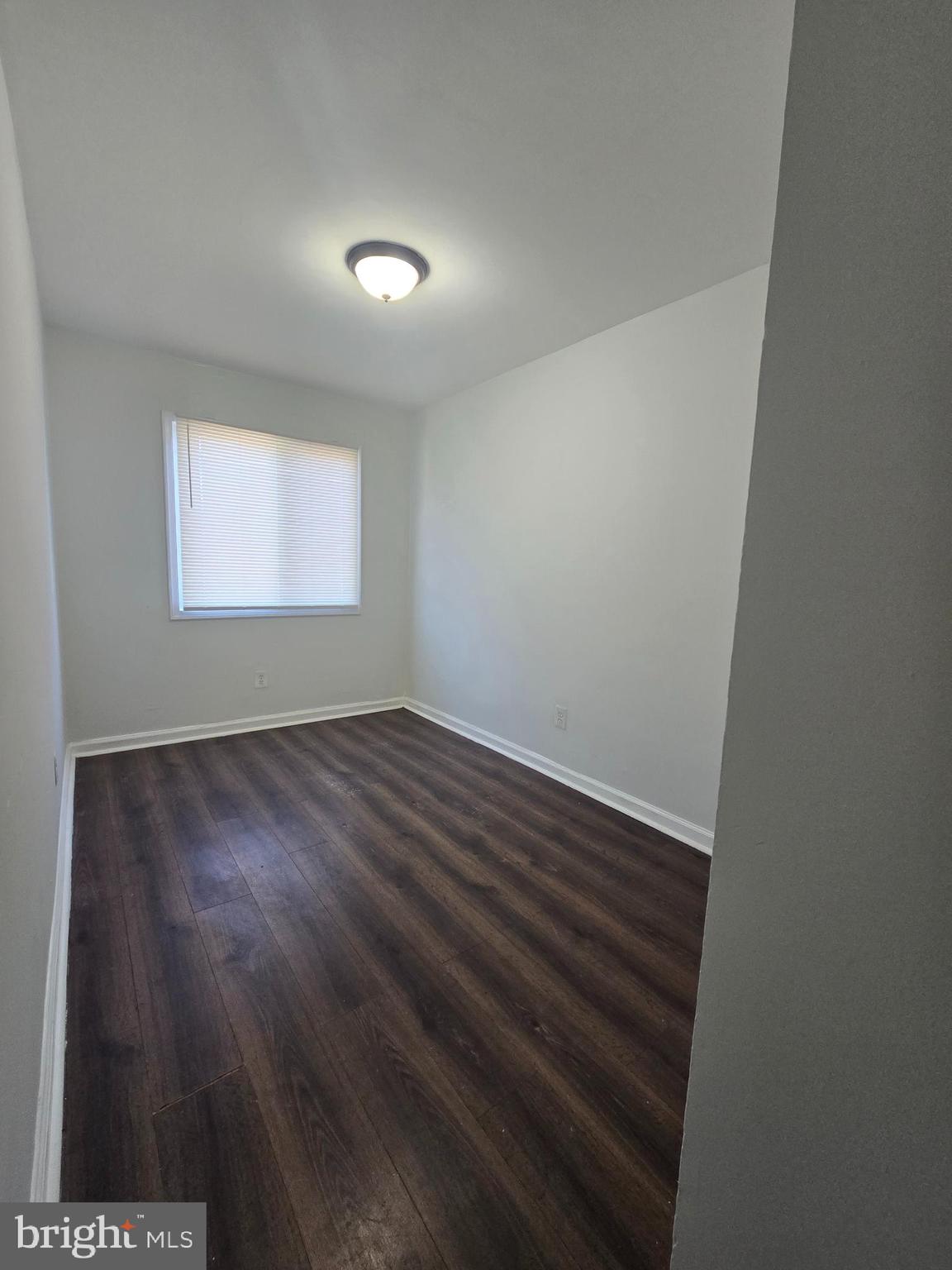 520 56th Street Northeast Washington, DC 20019 - Photo 2 of 15 an empty room with wooden floor and windows