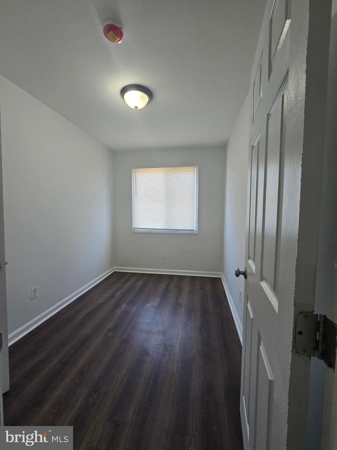 520 56th Street Northeast Washington, DC 20019 - Photo 3 of 15 an empty room with wooden floor and windows
