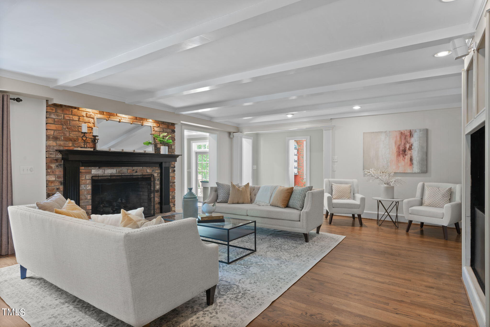 3919 Regent Road Durham, NC 27707 - Photo 16 of 87 a living room with furniture a fireplace and a flat screen tv