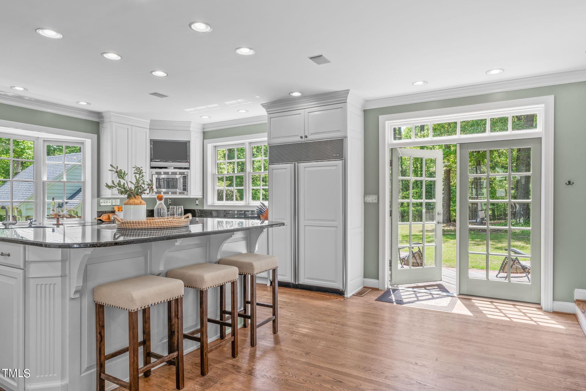 3919 Regent Road Durham, NC 27707 - Photo 28 of 87 a kitchen with stainless steel appliances granite countertop a table and chairs in it