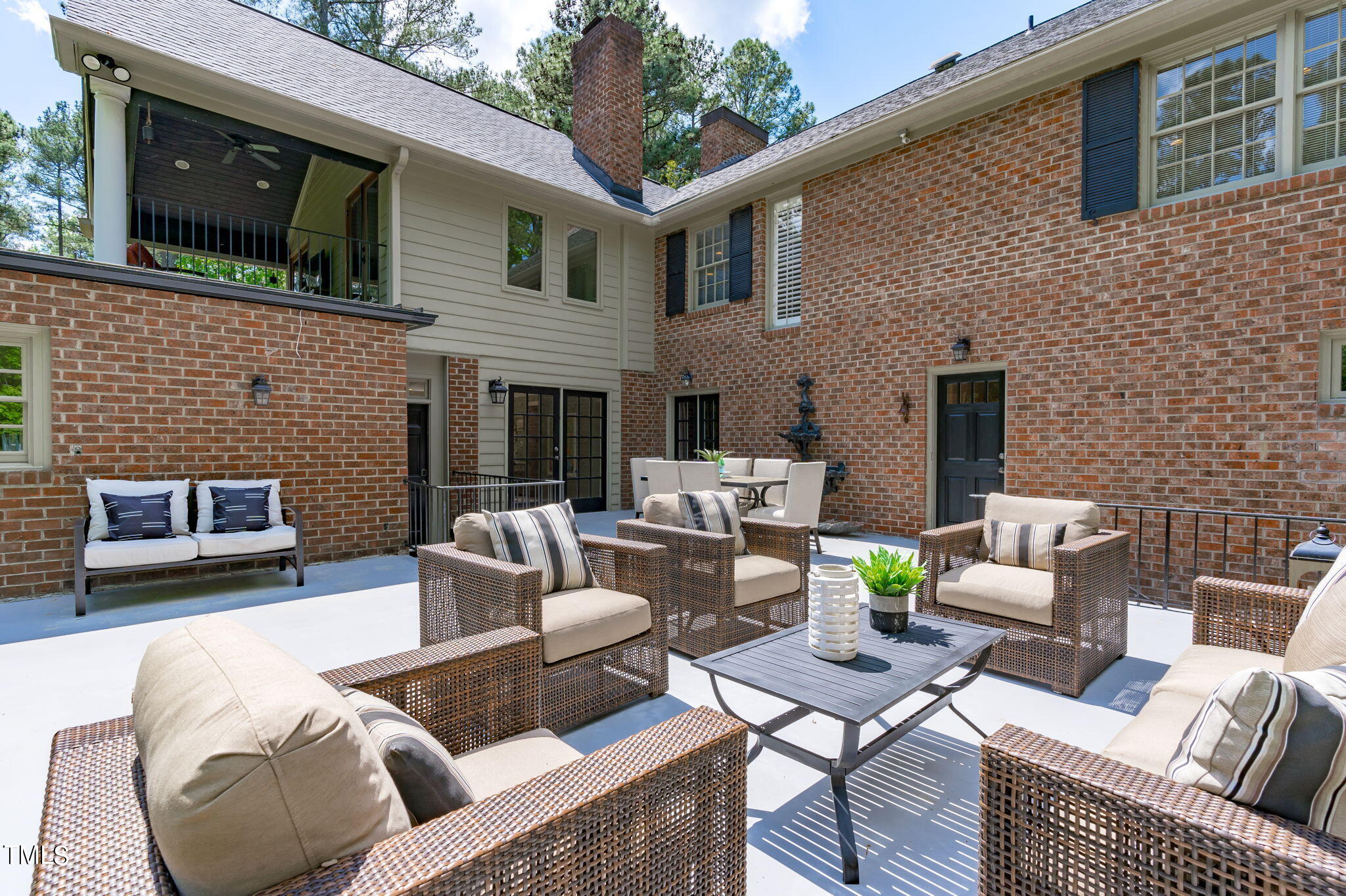 3919 Regent Road Durham, NC 27707 - Photo 74 of 87 a view of a patio with couches table and chairs with potted plants