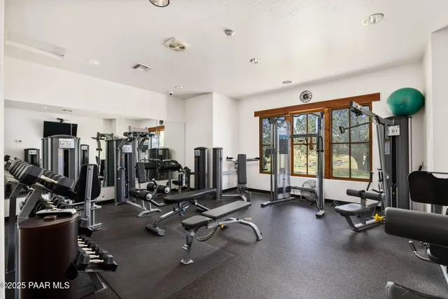 a view of a patio with table and chairs with wooden fence