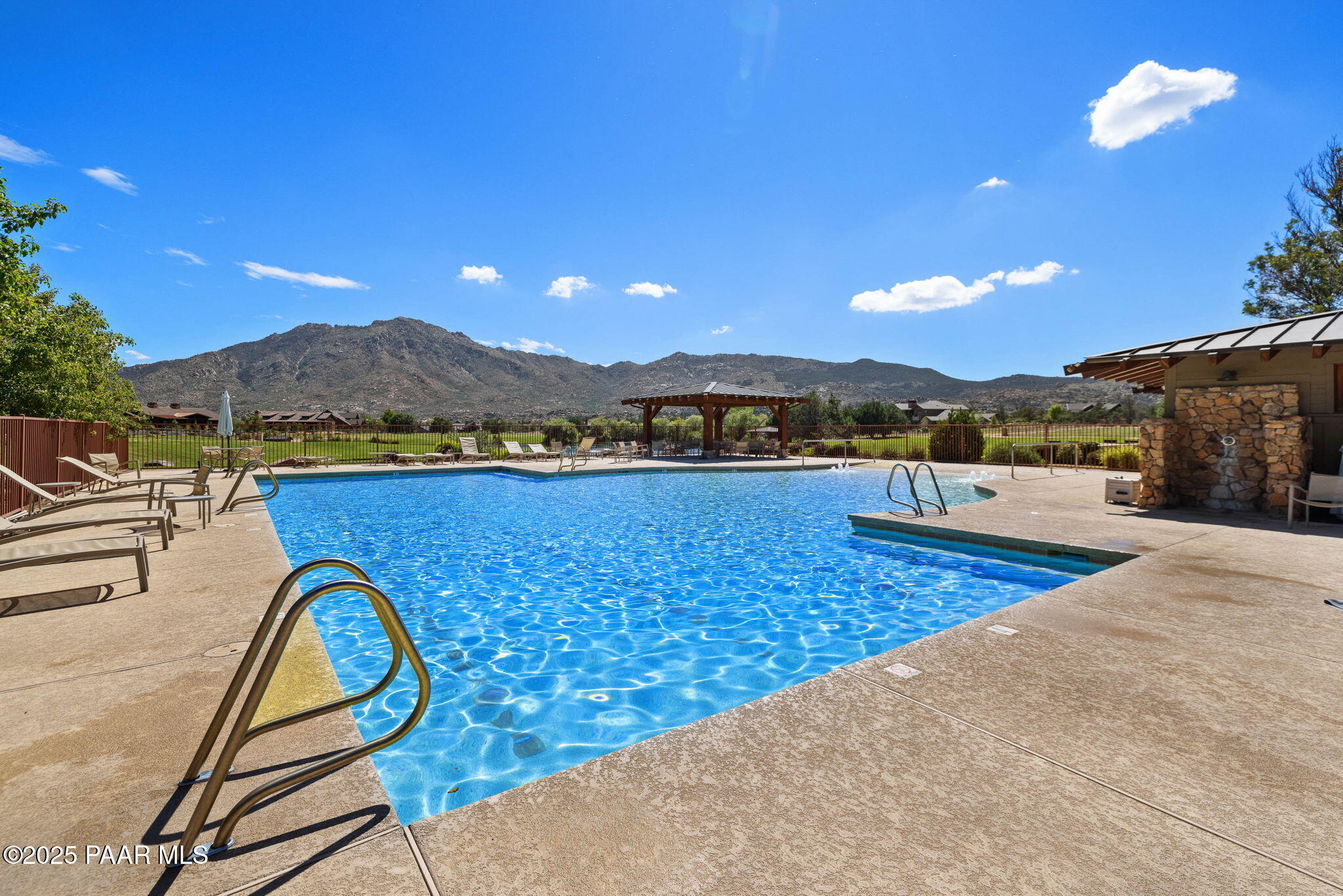 9515 North Equine Road Prescott, AZ 86305 - Photo 33 of 51 a view of a swimming pool with a lounge chair and a large tree