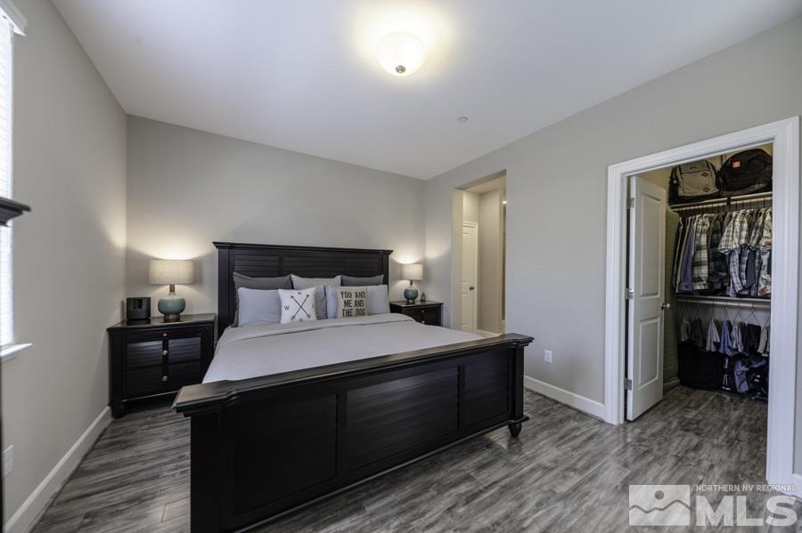 2029 Wind Ranch Road, Unit A Reno, NV 89521 - Photo 14 of 26 a bedroom with a bed and a refrigerator
