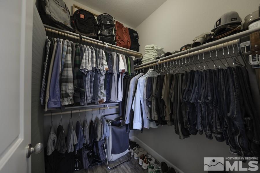 2029 Wind Ranch Road, Unit A Reno, NV 89521 - Photo 17 of 26 a view of walk in closet with clothes and shoes