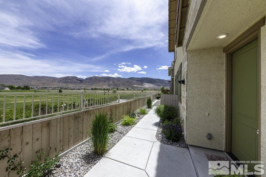 2029 Wind Ranch Road, Unit A Reno, NV 89521 - Photo 2 of 26 a view of a pathway with a wrought fence
