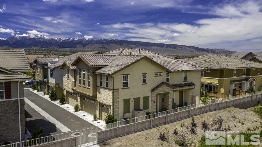2029 Wind Ranch Road, Unit A Reno, NV 89521 - Photo 3 of 26 a front view of a house with a yard