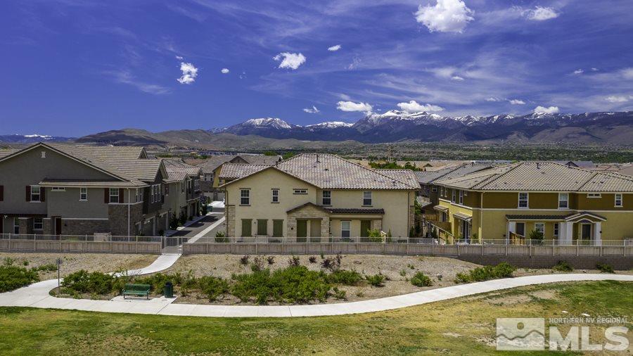 2029 Wind Ranch Road, Unit A Reno, NV 89521 - Photo 4 of 26 a front view of a house with a garden and a swimming pool