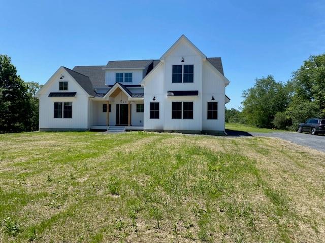 143 Decker Road Middletown, NY 10940 - Photo 1 of 1 Modern farmhouse style home featuring a front yard, a standing seam roof, and a metal roof