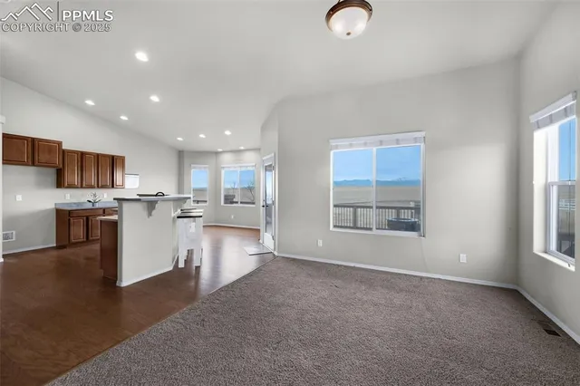 an empty room with windows and entrance