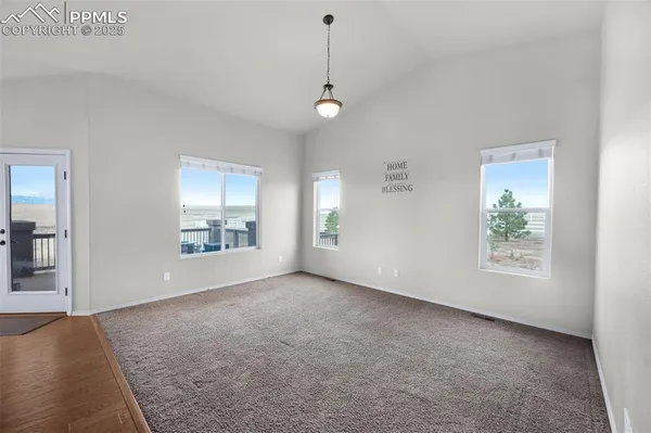 an empty room with windows and entrance