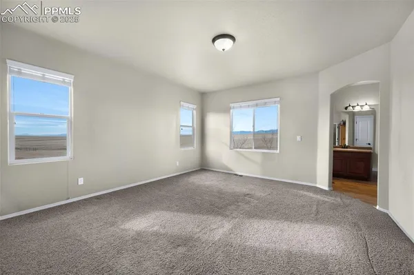 an empty room with windows and closet