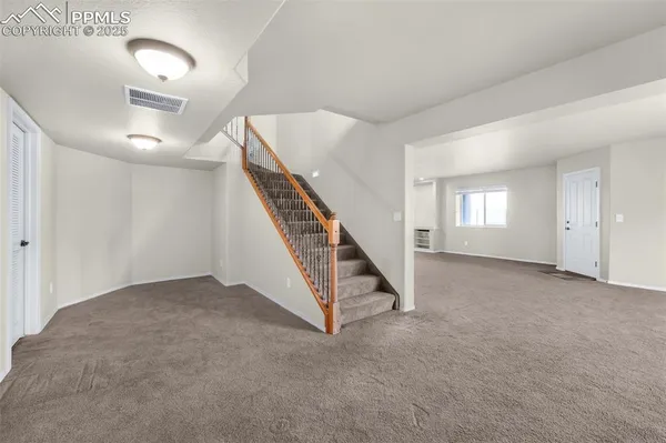 a kitchen with a refrigerator a sink and dishwasher with wooden cabinets